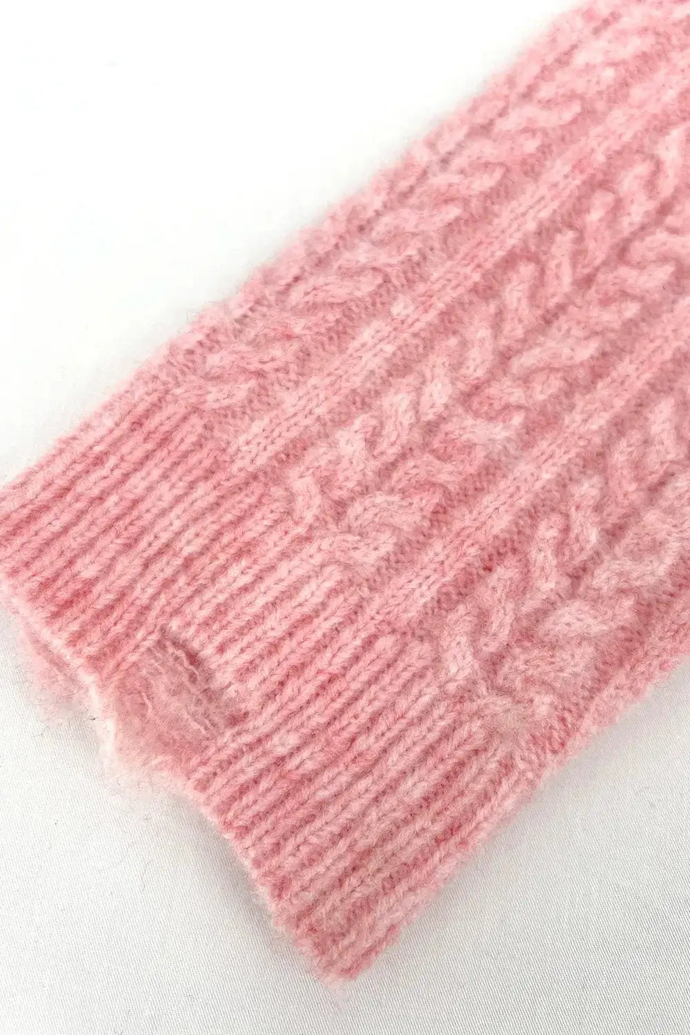 Close-up of the cable-knit texture on the Cable-Knit Striped Dropped Shoulder Sweater in soft pink.