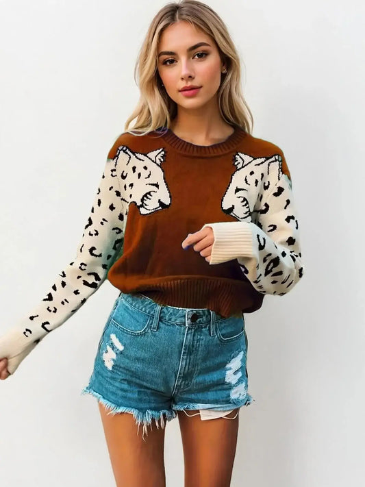 Woman wearing a Leopard Print Crew Neck Sweater with jeans, showcasing bold fashion style.