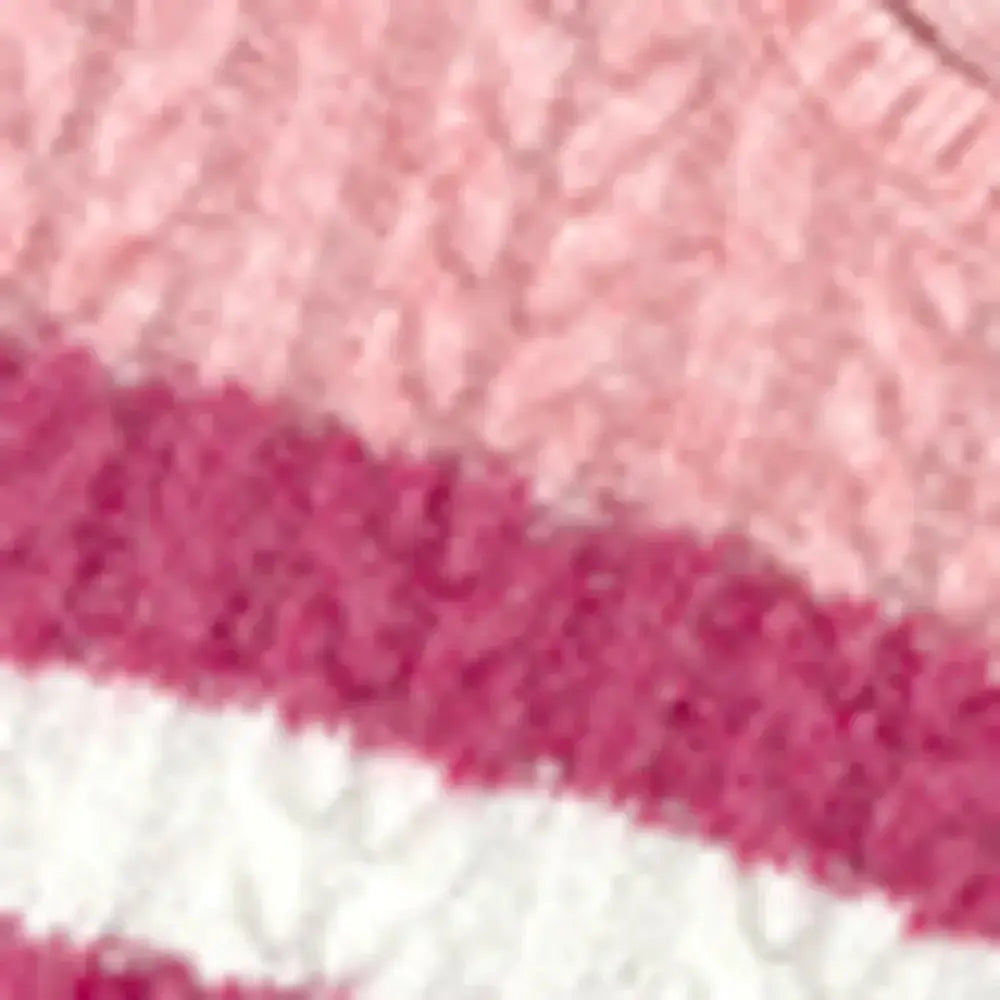 Close-up view of the texture and colors of the Cable-Knit Striped Dropped Shoulder Sweater.