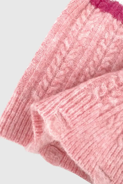 Close-up of the Cable-Knit Striped Dropped Shoulder Sweater showing textured pink fabric and intricate knit design.