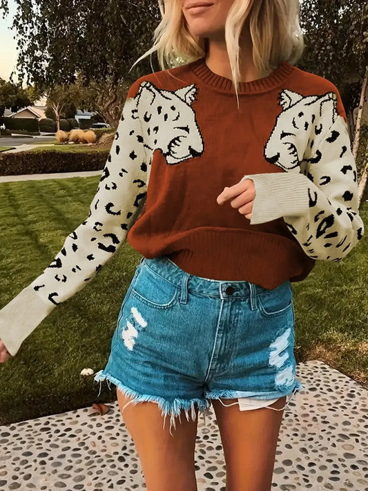 Stylish woman wearing a Leopard Print Crew Neck Sweater with brown and cream colors, paired with denim shorts, outdoors.